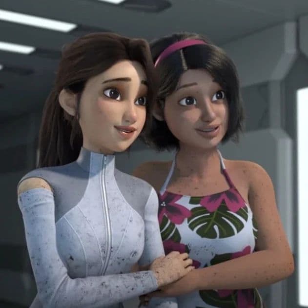 Two young girls embrace.